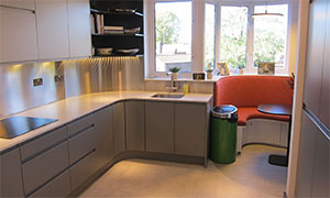 GEC Anderson stainless steel splashbacks used to good effect in curvy kitchen